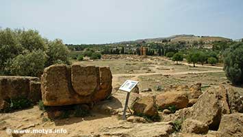 A view of the lower acropolis with the temple of the Dioscuri. In front a block with the typical U form used to pass the ropes to elevate the blocks with a crane. A view of the lower acropolis with the temple of the Dioscuri. In front a block with the typical U form used to pass the ropes to elevate the blocks with a crane.