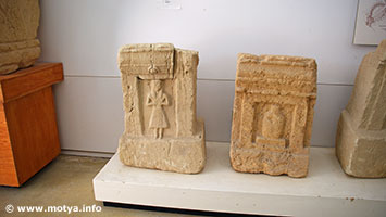 Steles of the tofet of Motya. On the left side with female, on the right side a stilistic figure commonly referred to as a bottle form, even though bottles at that time did not exist. Steles of the tofet of Motya. On the left side with female, on the right side a stilistic figure commonly referred to as a bottle form, even though bottles at that time did not exist.